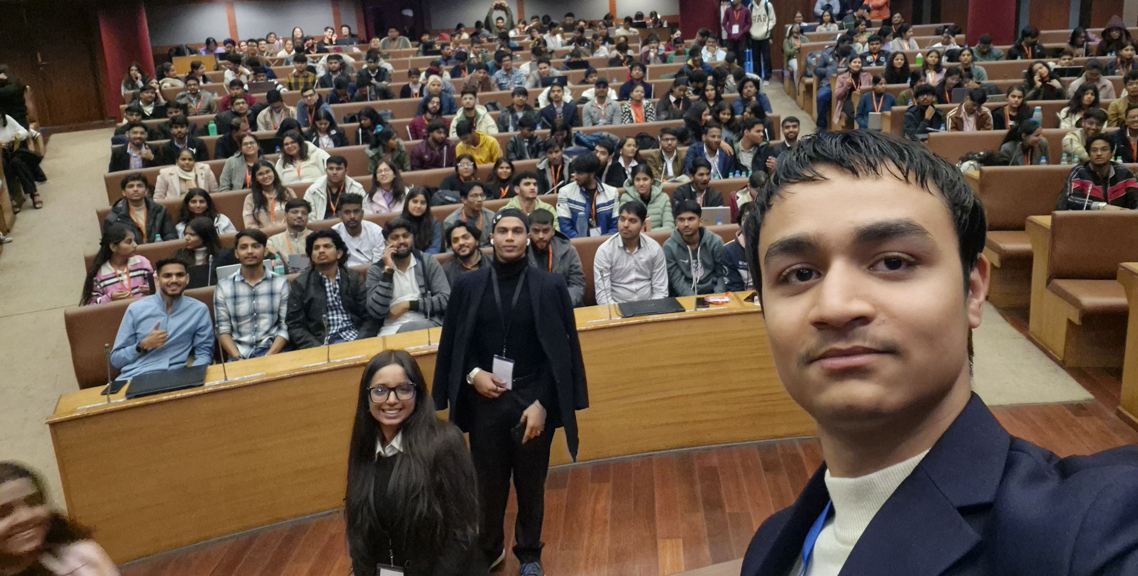 Neeraj on stage facing an audience during a speaking session